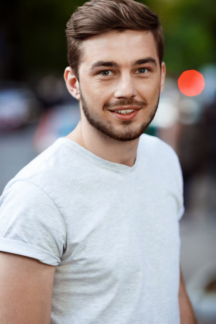 files/close-up-portrait-handsome-smiling-young-man-white-t-shirt-blurry-outdoor-nature_176420-6305.avif